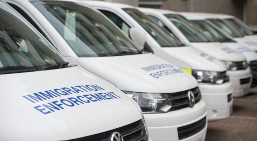 Immigration enforcement vans stand parked in at Home Office immigration centre in South London.