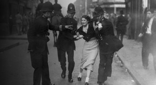 Woman being led away by police officers