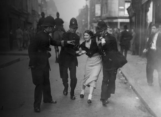 Woman being led away by police officers