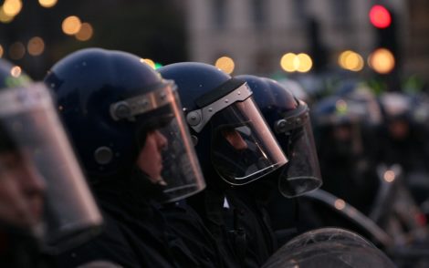 Riot police in helmets.