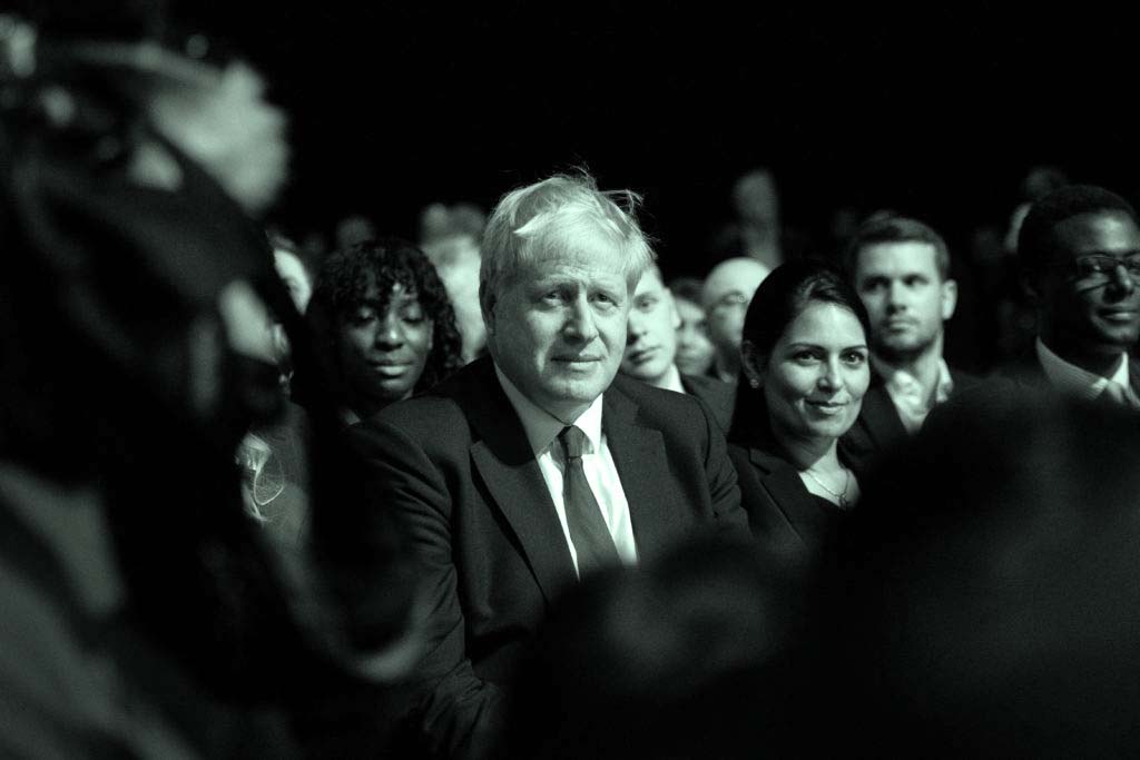 Boris Johnson and Priti Patel watch Chancellor of the Exchequer Sajid Javid deliver his Conference speech.