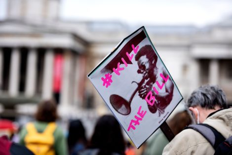 Protestor holding a placard that reads '#KILL THE BILL'.